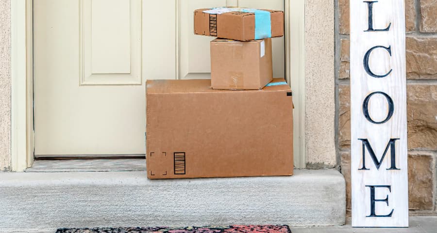 Deliveries on the front porch of a house with a welcome sign in Monroe